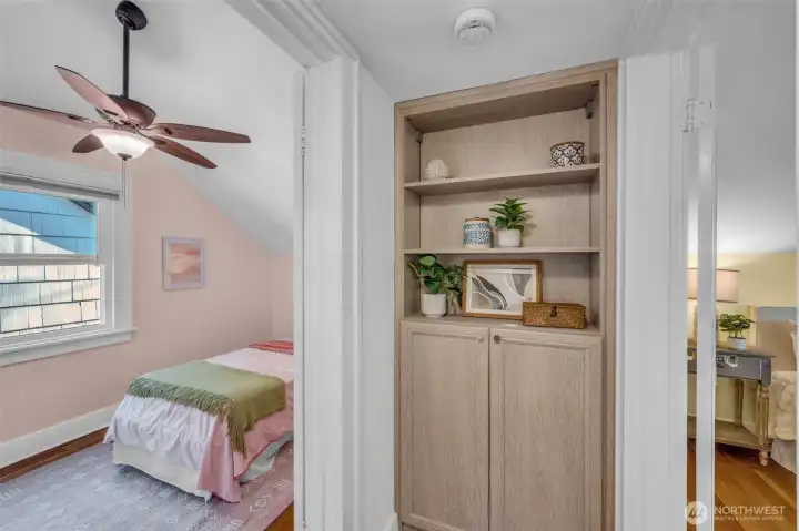 Built-in linen closet sits between the two bedrooms