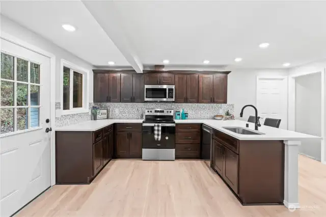 Wide-Open Kitchen w/Quartz Counters and Gorgeous Custom Tile Backsplash. Brand New Stainless Steel Appliances!