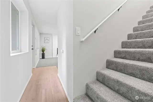 Reaching the bottom of the stairs, head forward to Family Room or go into the bedroom behind you.