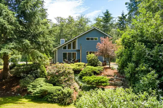 Gabled view of the home amidst a beautifully landscaped garden. Maybe this is the one...