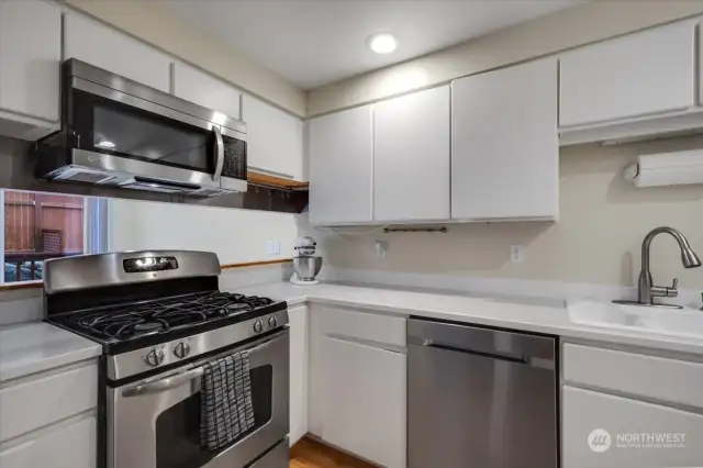 Kitchen features a gas stove and stainless appliances.