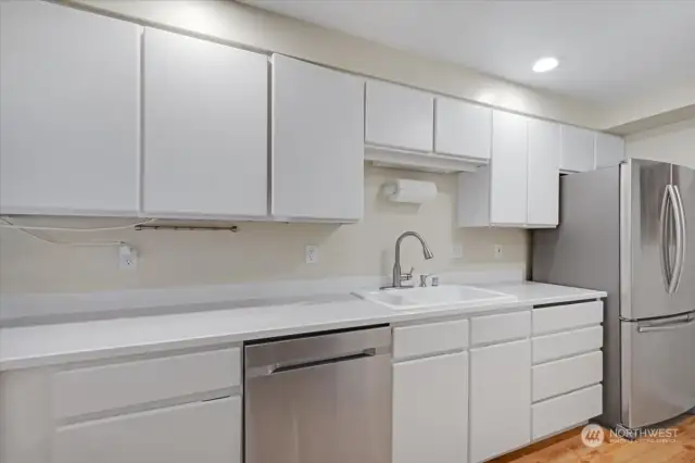 Kitchen has ample cabinets and counter space.