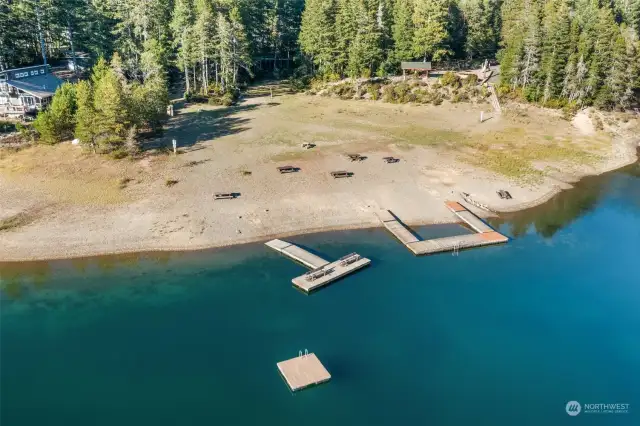 Zoomed in view of community park. Docks, volleyball court, horshoe, playground and picnic/BBQ area.