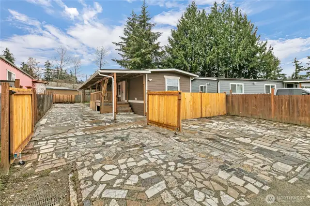 Front of home with fence open to driveway