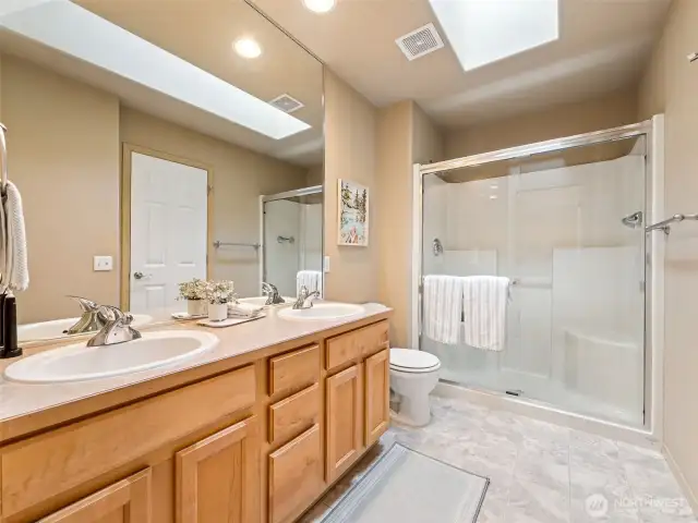 - With double sinks & large walk-in shower + skylight for natural lighting!