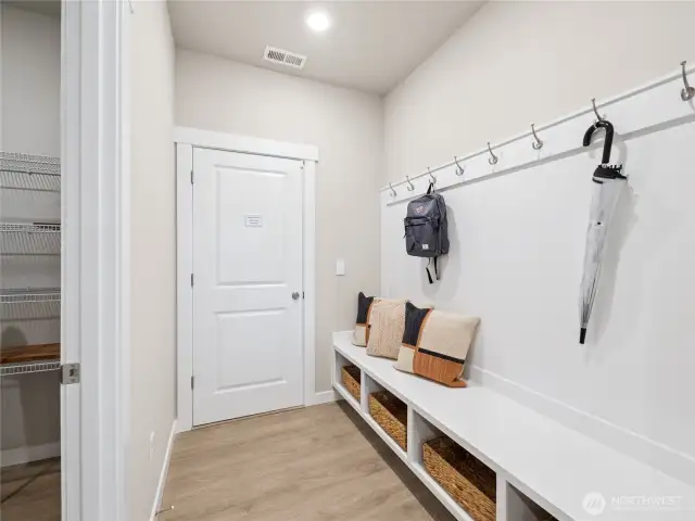 Built-in dropzone with bench, cubbies, and coat hanging area.    Photo is representational. Actual home is under construction and finishes and colors will vary. See site agent for details.