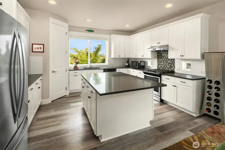 This modern kitchen will satisfy any cook. Solid surface counters and a spacious center island for meal prep and holiday buffets.