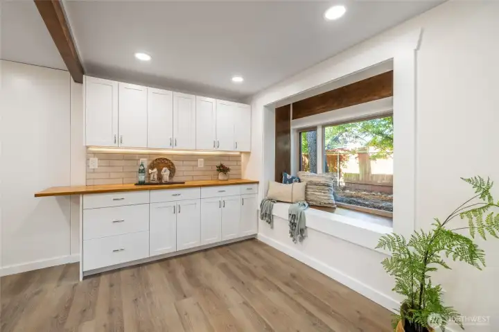 Butcher block countertop on one bank of HighCraft custom cabinets. Room for kitchen table here. Bay window bench seat.