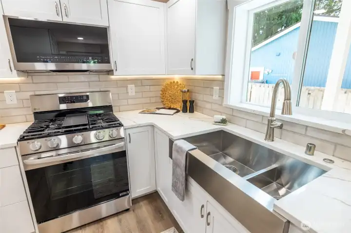 Oversized farm sink. Air switch operated garbage disposal. Quartz counter tops. Custom HighCraft cabinets.