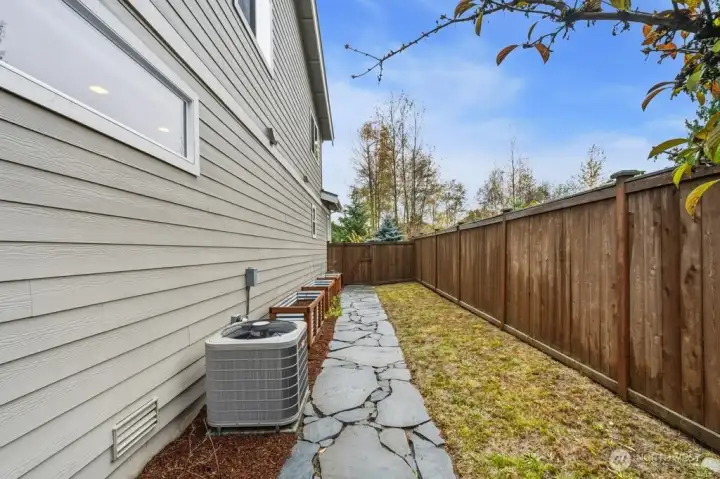 Grassy side yard with raised bed and garden space