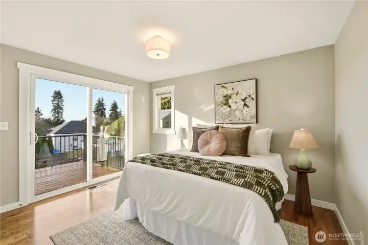 There are 3 bedrooms  on the main level including this spacious bedroom with access to the view deck!