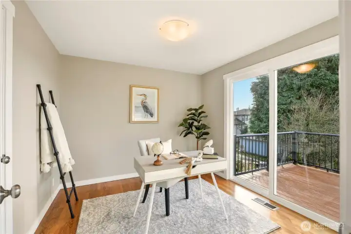 The second bedroom also enjoys access to the view deck. It's staged as an office.