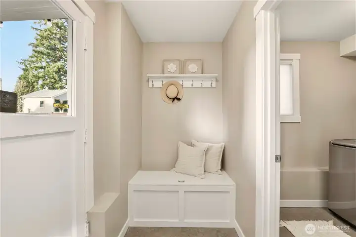 The current owners have thoughtfully designed multiple storage areas, including this bench seating with storage underneath in the mud room. This is a perfect place to take off your shoes and coat after enjoying the back yard.