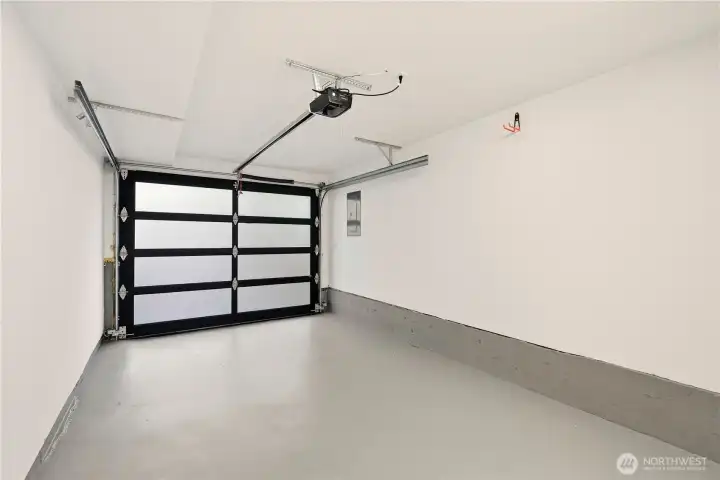 Yes, a beautifully finished and painted one car garage with utility closet that houses the furnace and hot water heater and provides additional storage. Just outside the garage on the south side of the home is a Emporia car charger that conveys to buyers.