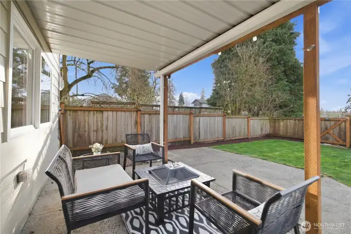 The lower level covered patio is a wonderful outdoor "room" to enjoy the westerly views and sunsets and/or watch the kids play in the fully fenced yard.