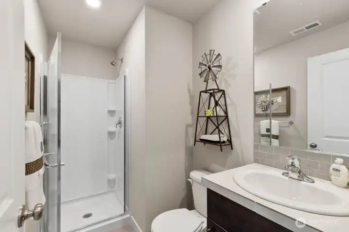 Convenient bathroom with shower on main floor. Photo's are for representational purposes only. Colors and finishes may differ.