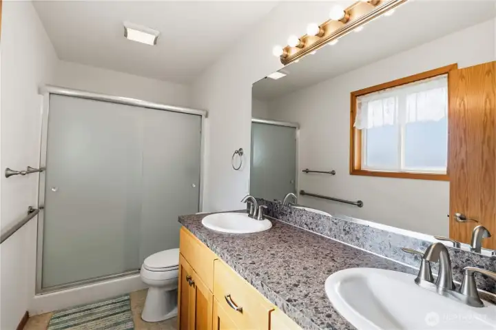 Primary bathroom with walk in shower & double sinks.