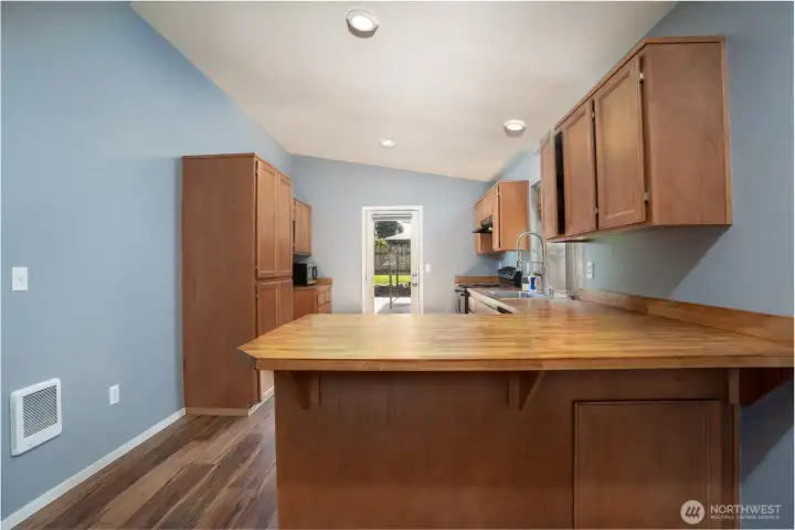 Functional kitchen layout with generous cabinetry, workspace, and a central island for added convenience.