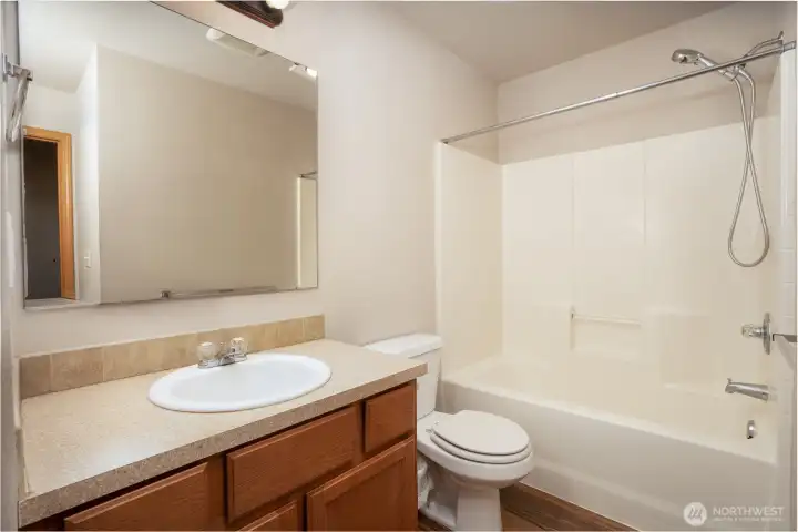 Well-maintained bathroom with a clean, functional layout and full tub/shower.