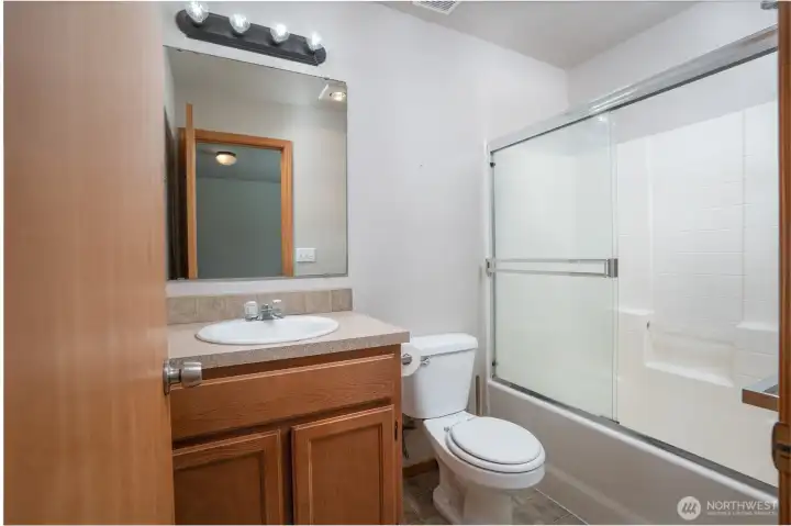 Private en-suite bathroom with a full tub/shower-adding comfort, convenience, and everyday ease to the primary suite.