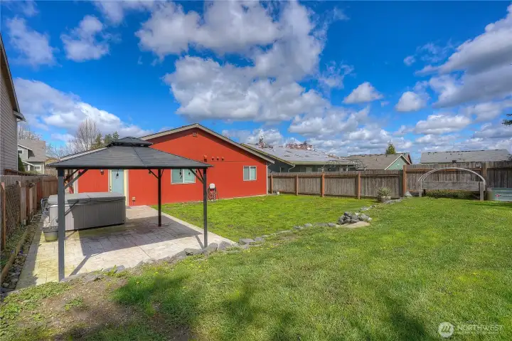 Spacious backyard with room for pets, play, BBQ grilling, and family fun. A perfect setting for everyday living and weekend gatherings.
