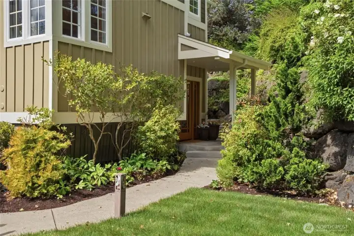 Entry to the right of the driveway.