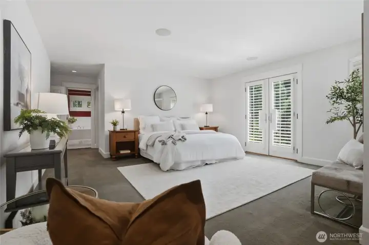 Primary bedroom suite with French doors and Juliet balcony.