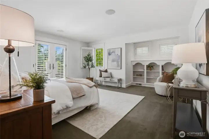 Primary bedroom showing bookcase alcove and plantation shutters.