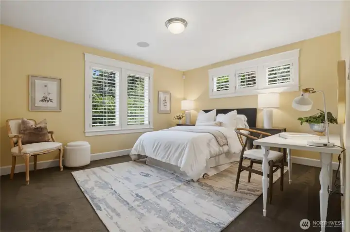 One of two guest bedrooms, also with plantation shutters.
