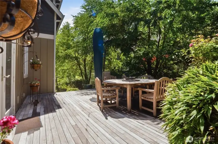 The back deck is a private, verdant garden with tropical hardwood decking and a ceramic fountain.