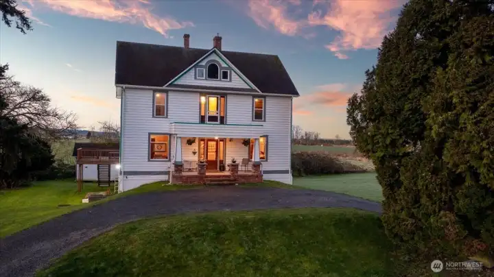 Front exterior in with the glow of the morning sunrise.