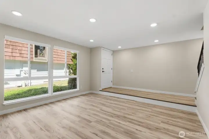 Oversized living room has ample natural light and new canned lights throughout.