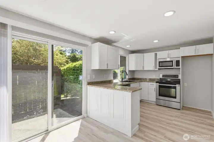 Slider opens to a private back patio and grassy common area, perfect for pets.
