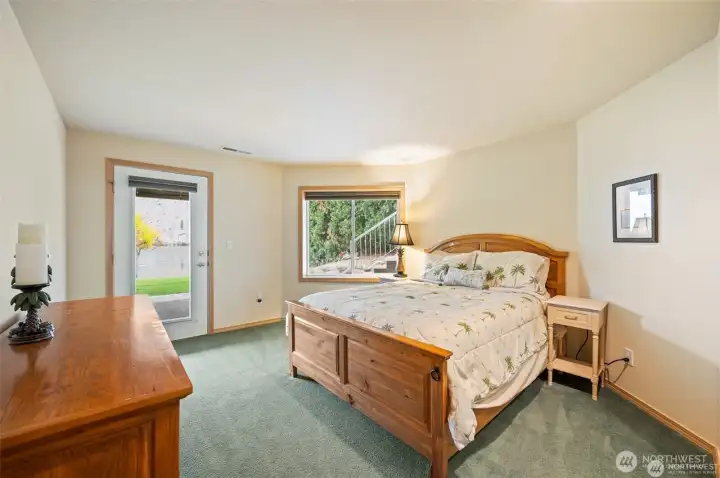 Spacious lower-level bedroom with direct access to the shoreline and community greenspace creates a relaxing retreat just steps from the water.