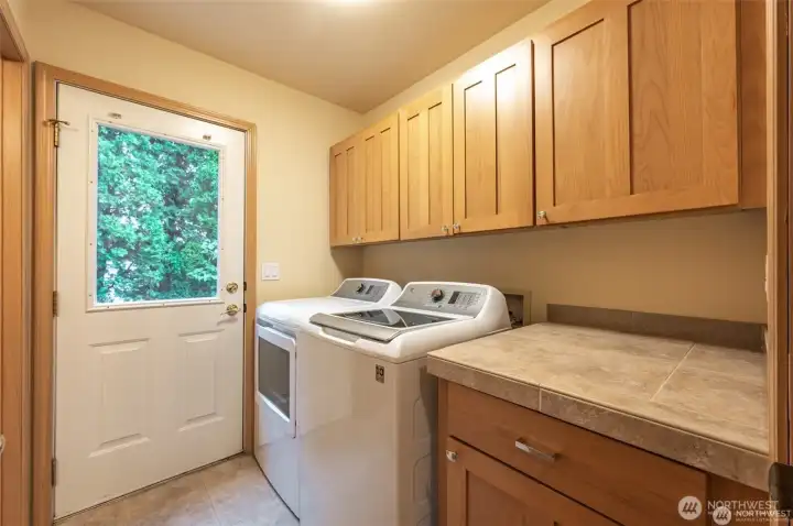 Functional laundry room with built-in storage and utility workspace adds convenience to everyday living and extended lake stays.