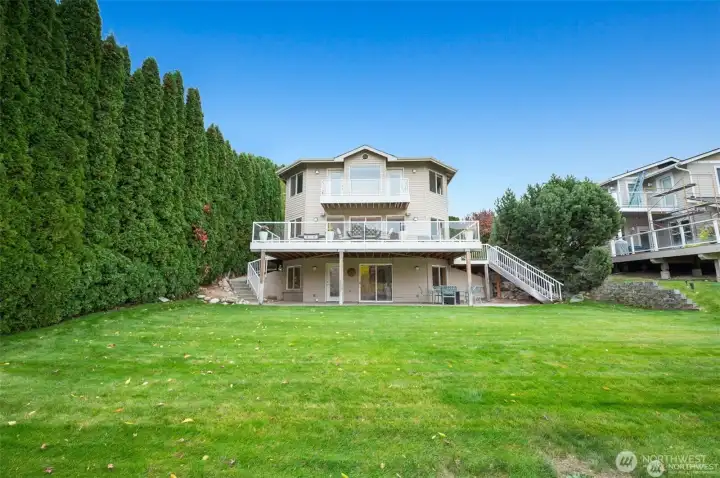 Beautifully maintained lawn and lower patio area provide seamless indoor-outdoor living with room to entertain and unwind.