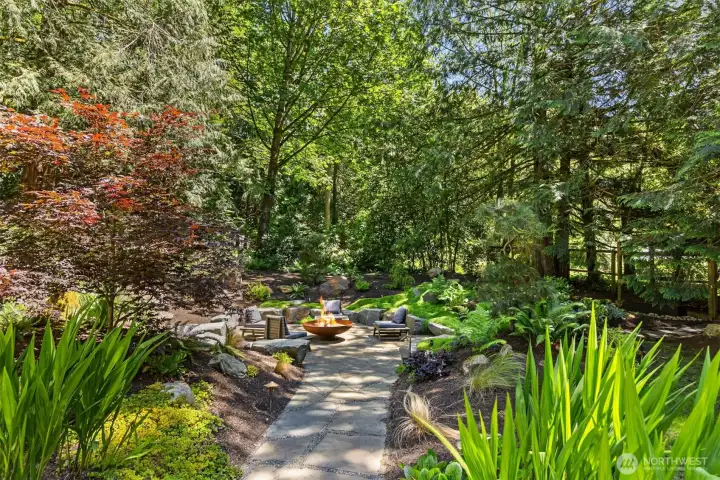 Custom designed outdoor fire pit with mature landscaping.  A perfect setting for sweet conversations.