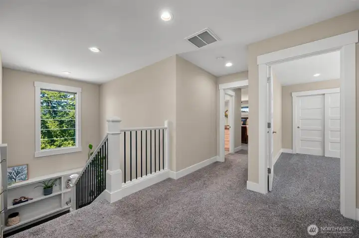 Leading upstairs to the Primary Suite, you will also find 2 more bedrooms + a full bath in the hallway.