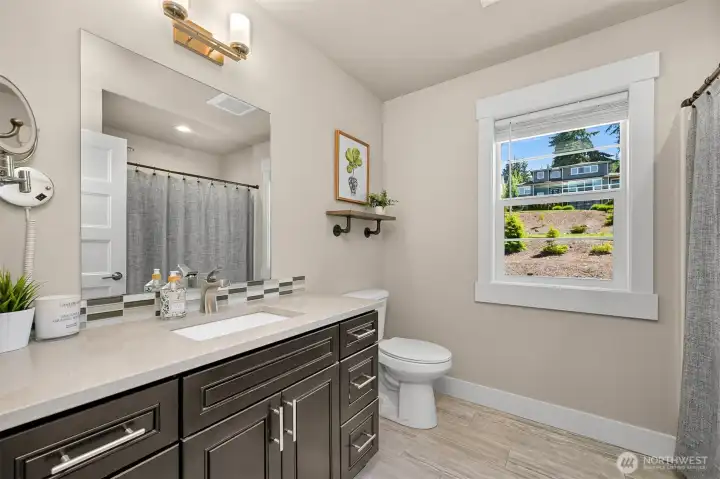 Full bathroom located between the two additional upstairs bedrooms