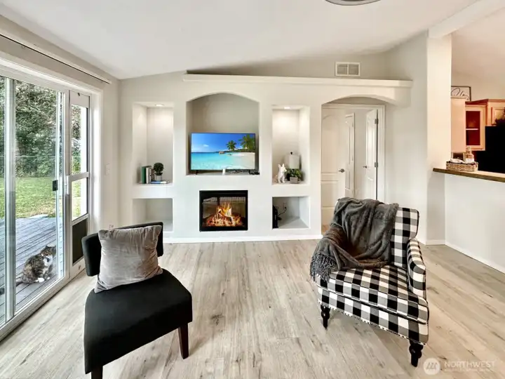 Living room with electric fireplace is flanked with display niches...perfect for books, speakers and game storage.