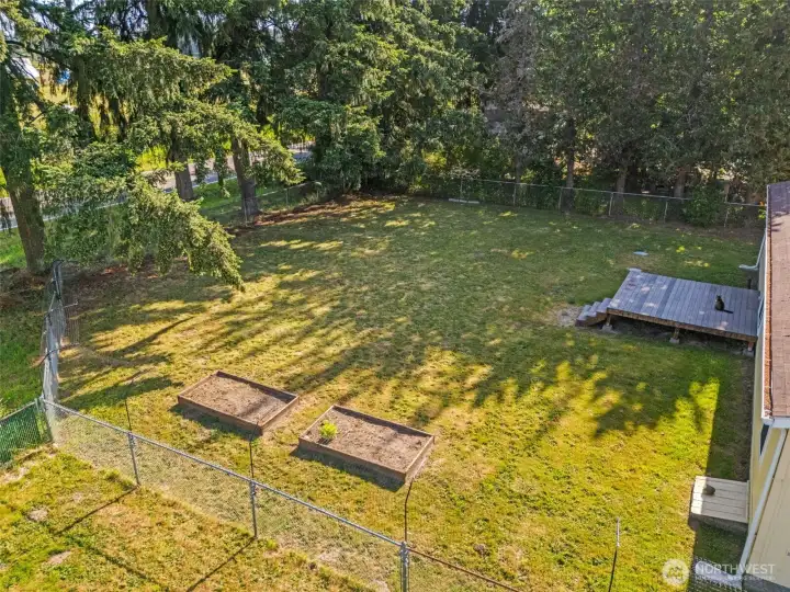 Just off the living room is the pet friendly rear yard with raised garden beds and composite deck.