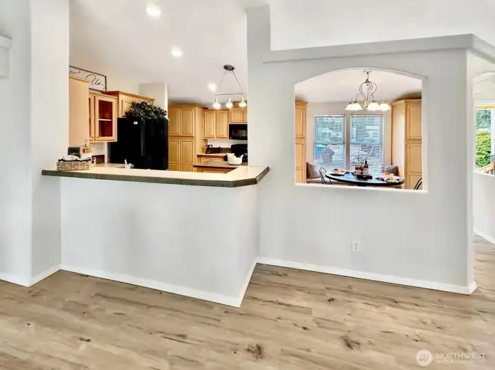 In this photo you see the eating bar between the living room and kitchen along with opening from the dining area. So open and airy with lots of natural light.