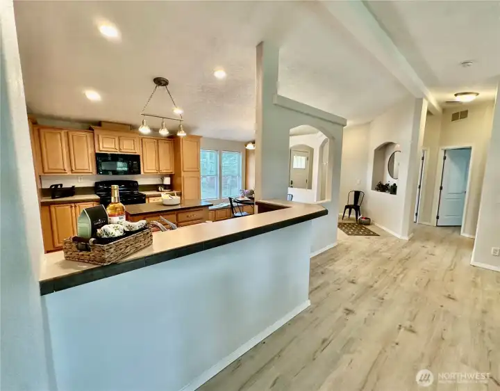 Looking into the kitchen and toward the bedroom/den hall.