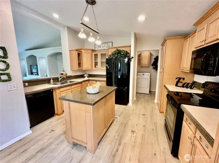 Wonderful kitchen complete with island, pantry cupboard, ample cabinets and counter space plus all appliances.