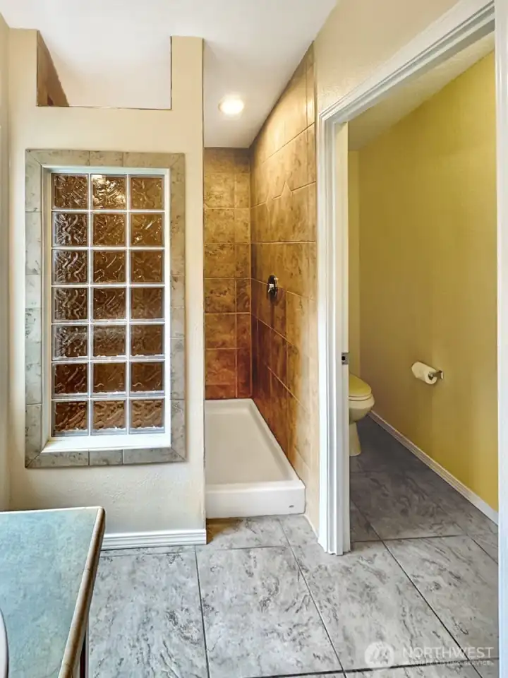 Primary view of the large shower and separate water closet.