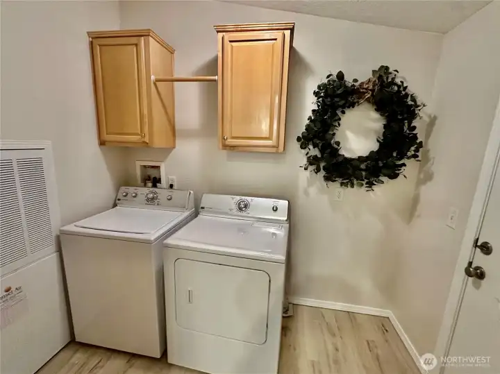Nice size laundry room with broom closet and washer and dryer included.  The door to the right in this photo opens to the attached 2 car garage.