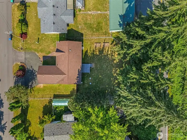 Aerial view, shows the circular driveway and  fenced year yard with composite deck.