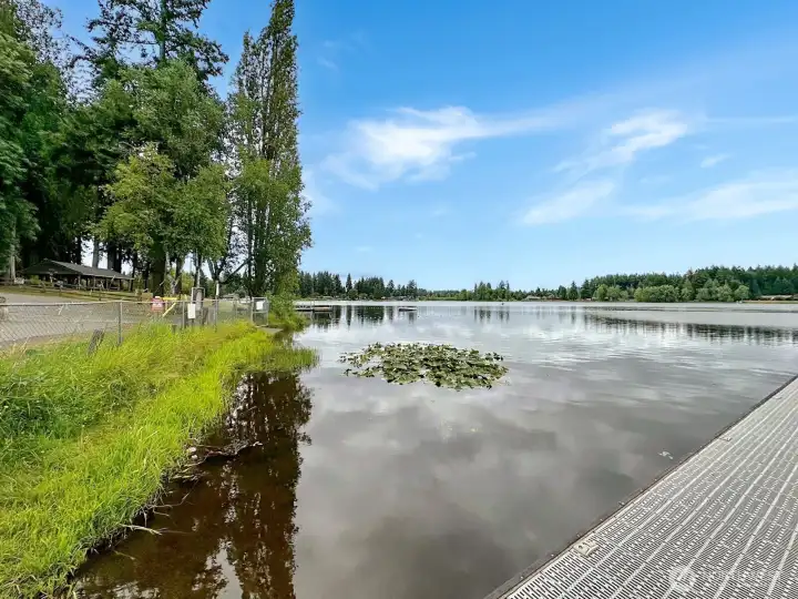 View from the community fishing dock looking  toward the covered picnic area and swimming dock.
