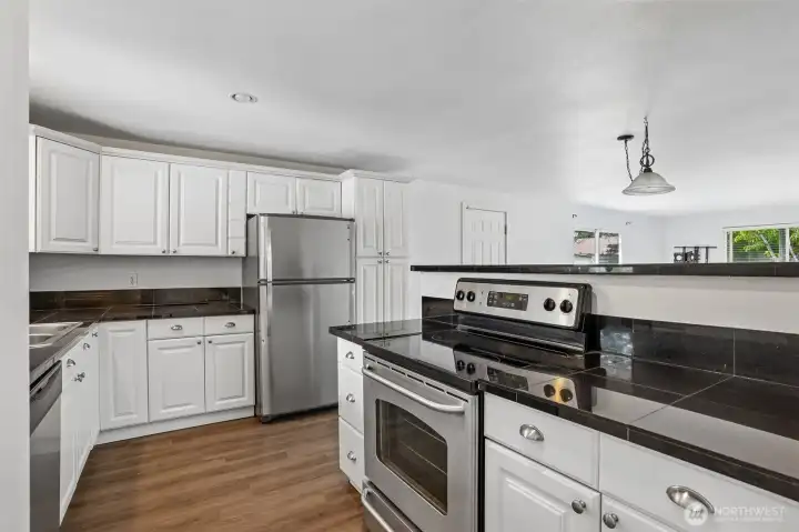 Kitchen with tile counters. Kitchen with tile counters.