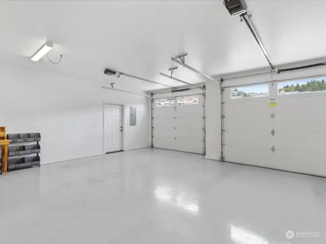 Enormous 3-car Garage with polished concrete floor, generator wired, lots of storage space +door outside for access to paved Parking pad & 2 gates.